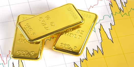 gold bars on top of financial graphs