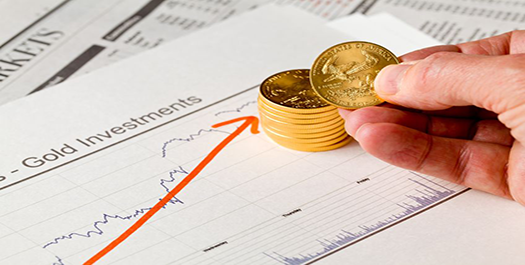 gold coins on top of gold investments graph